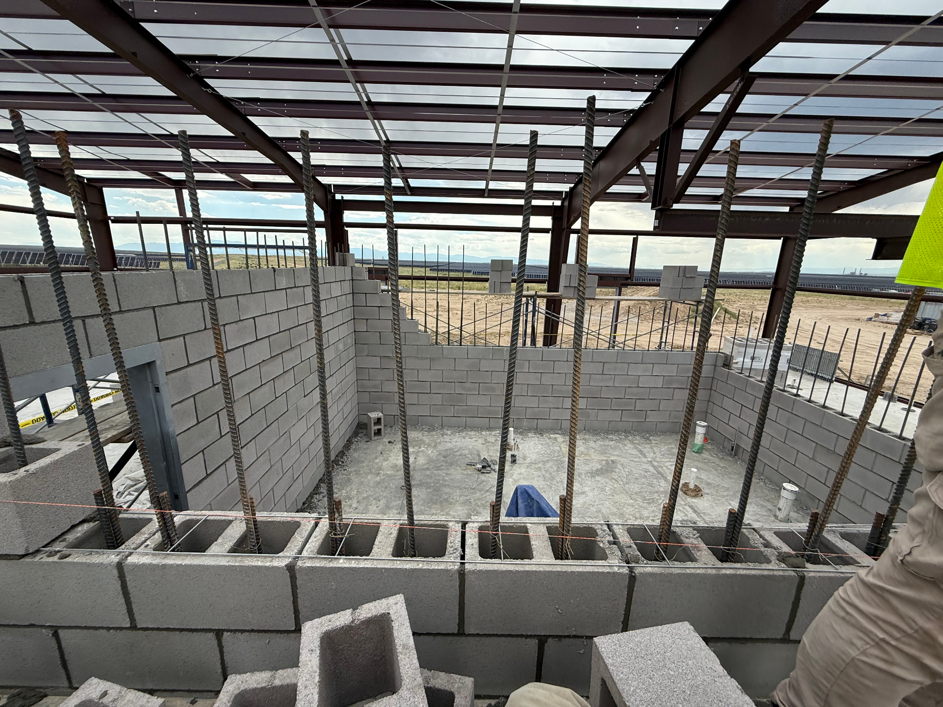 Reinforced CMU walls with vertical rebar inside a steel-framed structure