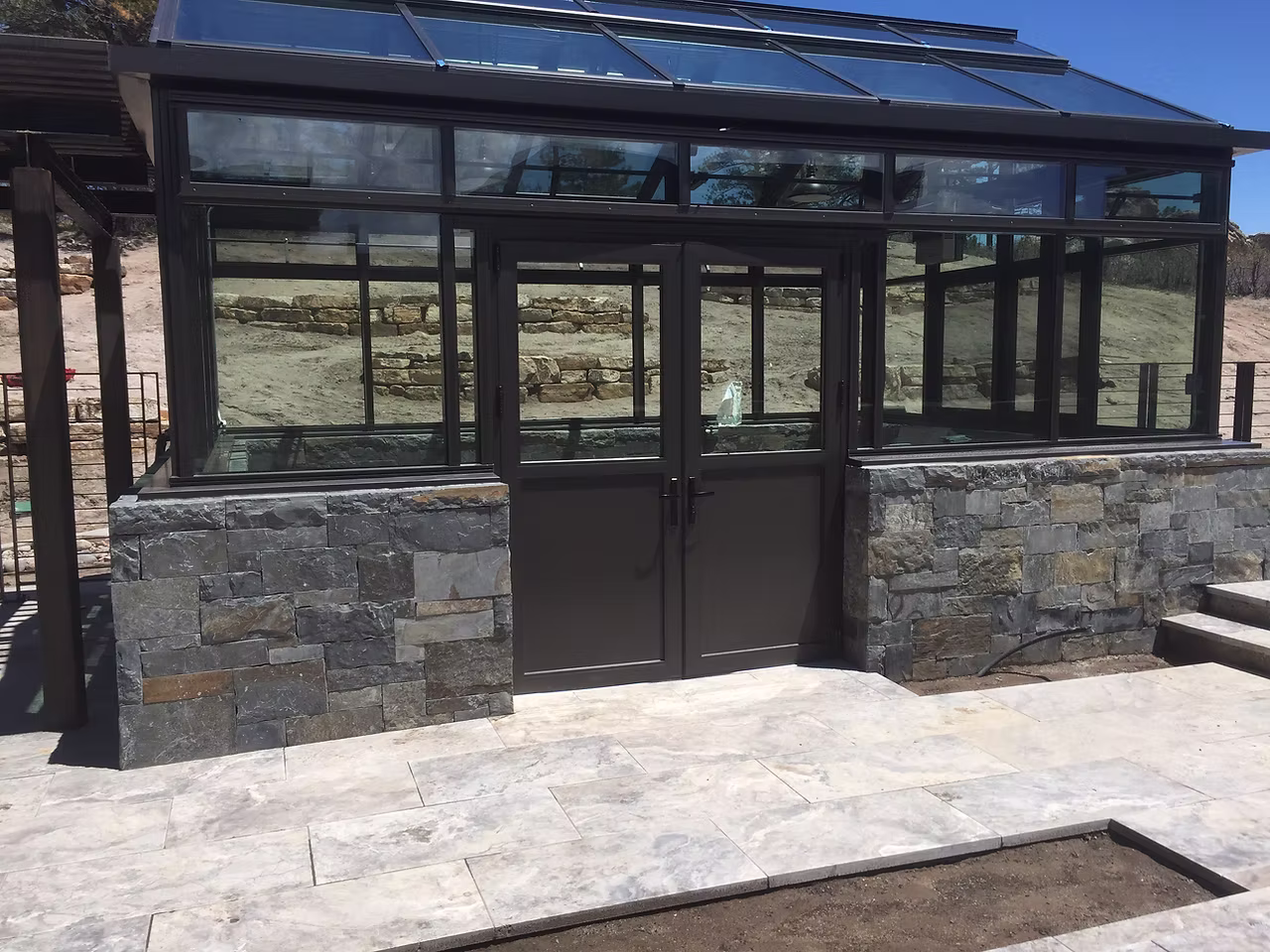 Outdoor living space with patio, fire pit, and stone features