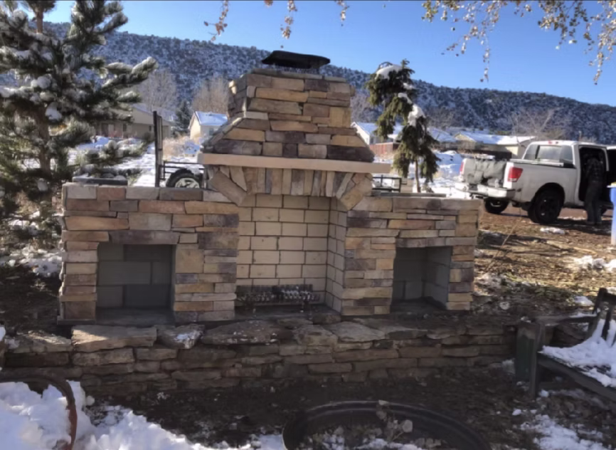 Outdoor living space with patio, fire pit, and stone features