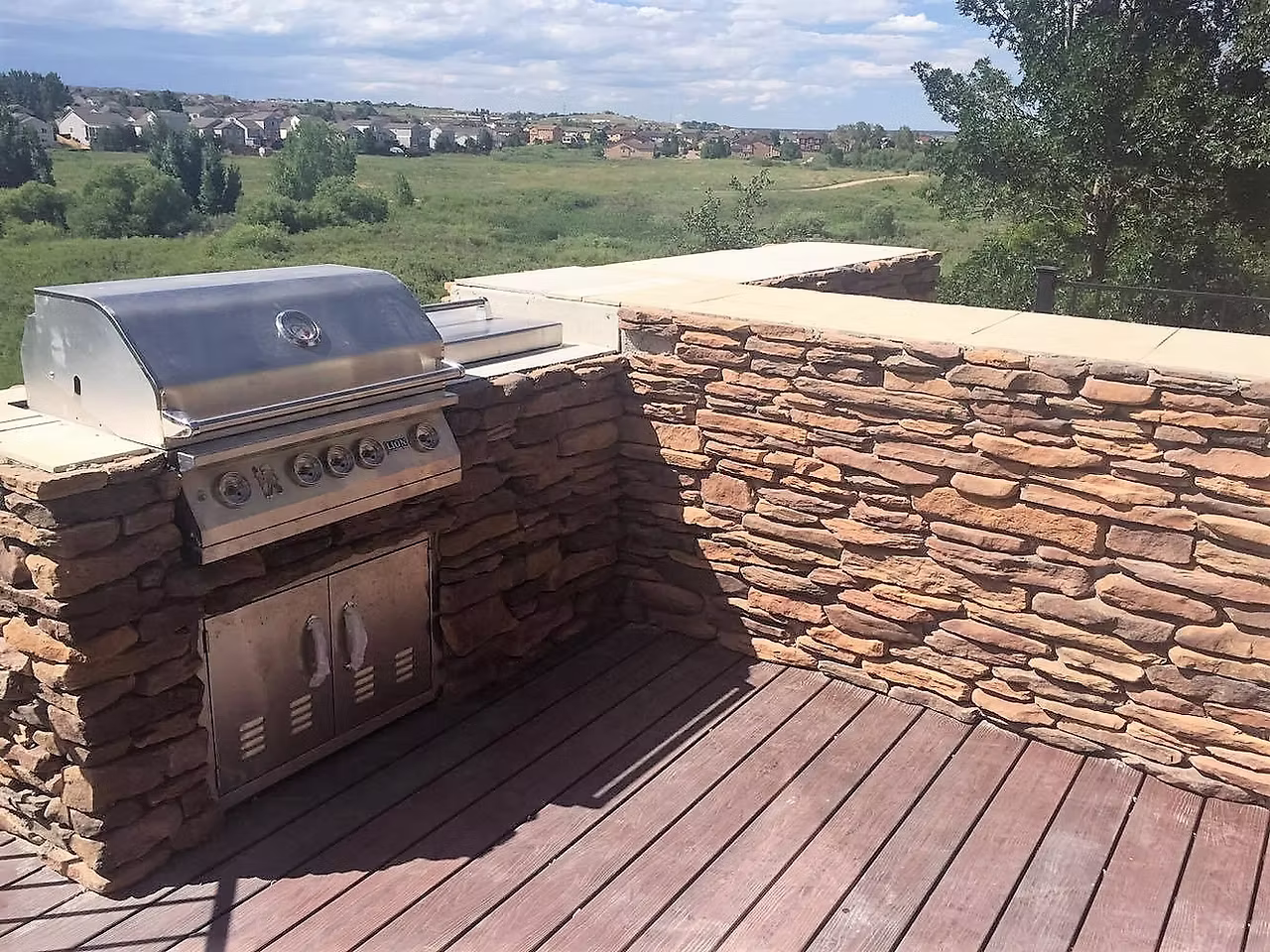 Outdoor living space with patio, fire pit, and stone features