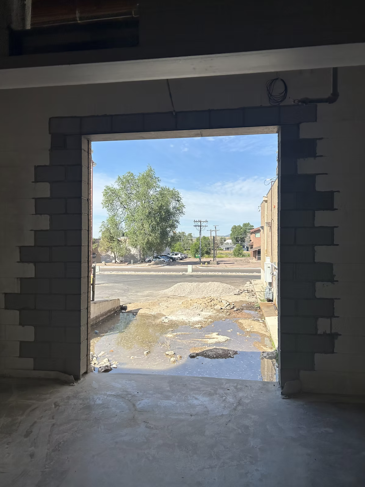 View through a restored commercial masonry doorway opening with new CMU jambs and header