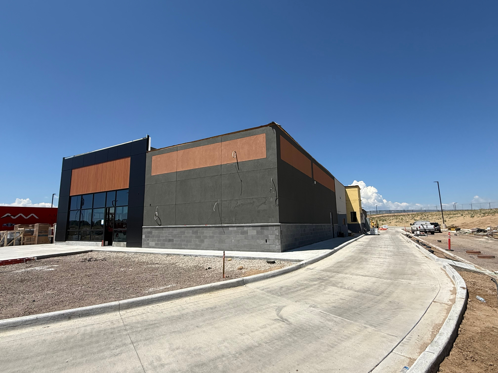 Two-tone commercial stucco facade with copper accent panels