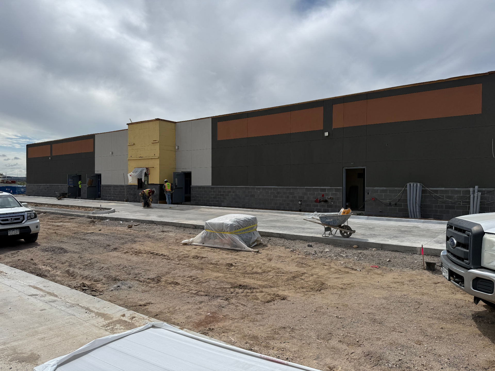 Long commercial stucco wall with banded color detailing